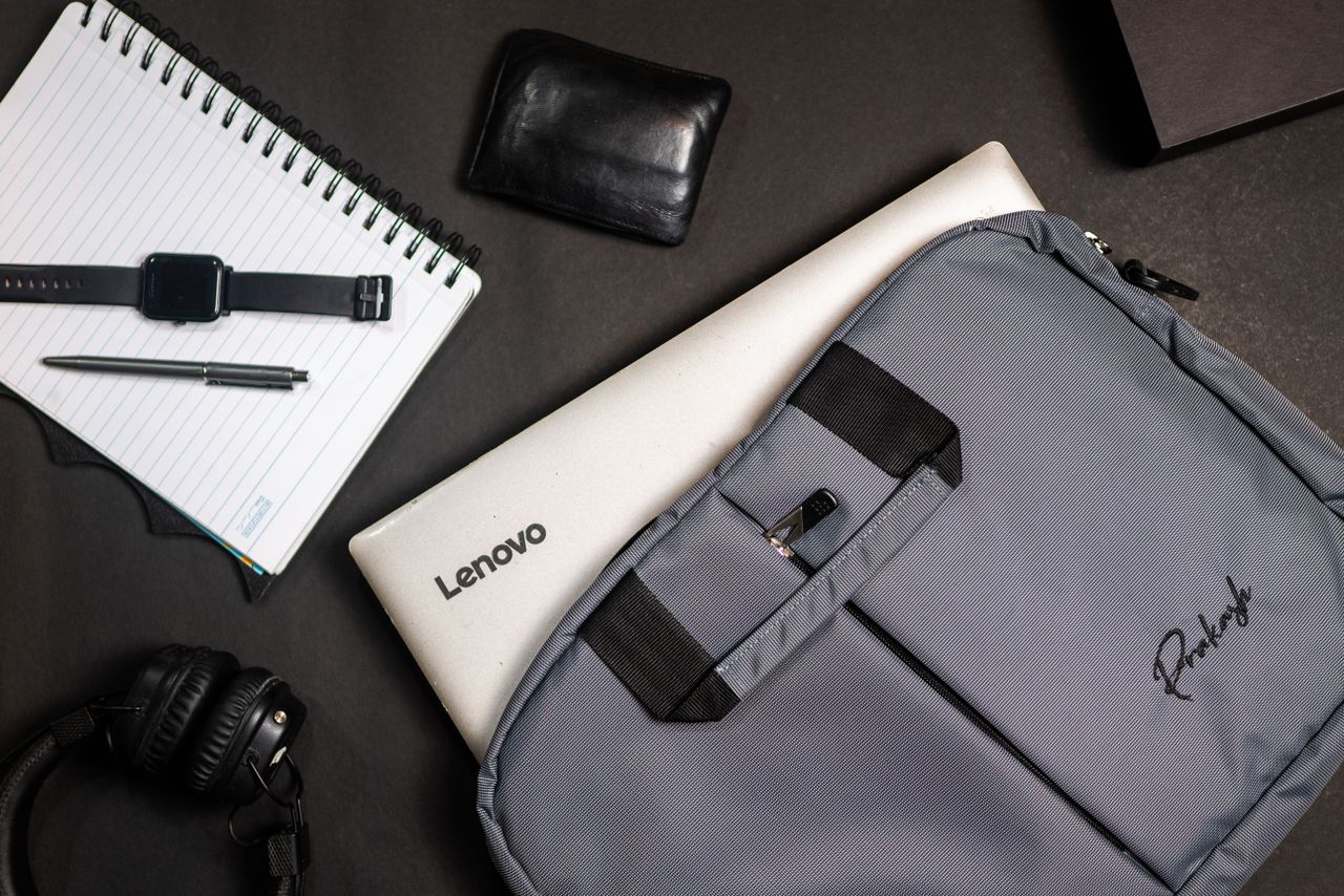 Services Top view of modern office essentials including a laptop, notebook, and accessories.