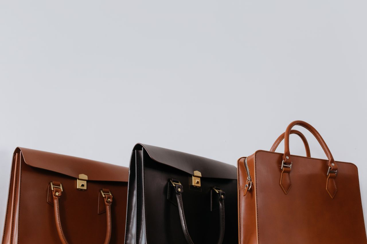 Home A close-up view of three elegant leather briefcases emphasizing luxury and fashion.